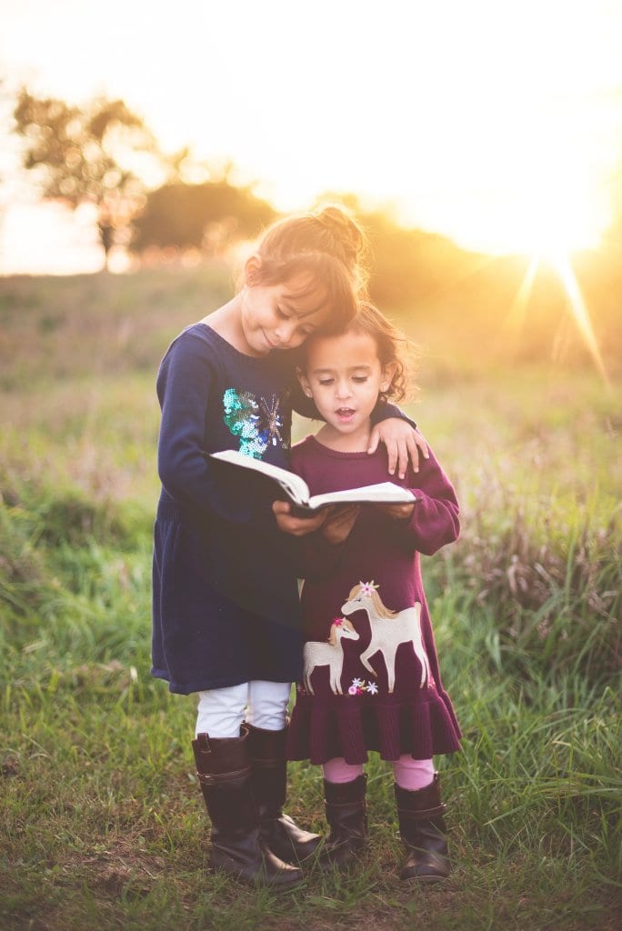 children reading together outside