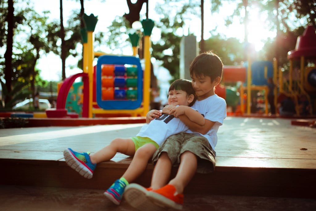 older brother playing with younger autistic brother