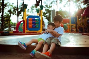 two young boys playing at a playground